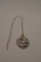Antiqued silver-tone floral pendant