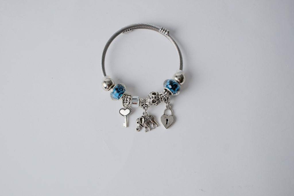 Pandora charm bracelet featuring an elephant, heart lock, and key charms