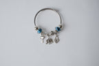 Pandora charm bracelet featuring an elephant, heart lock, and key charms