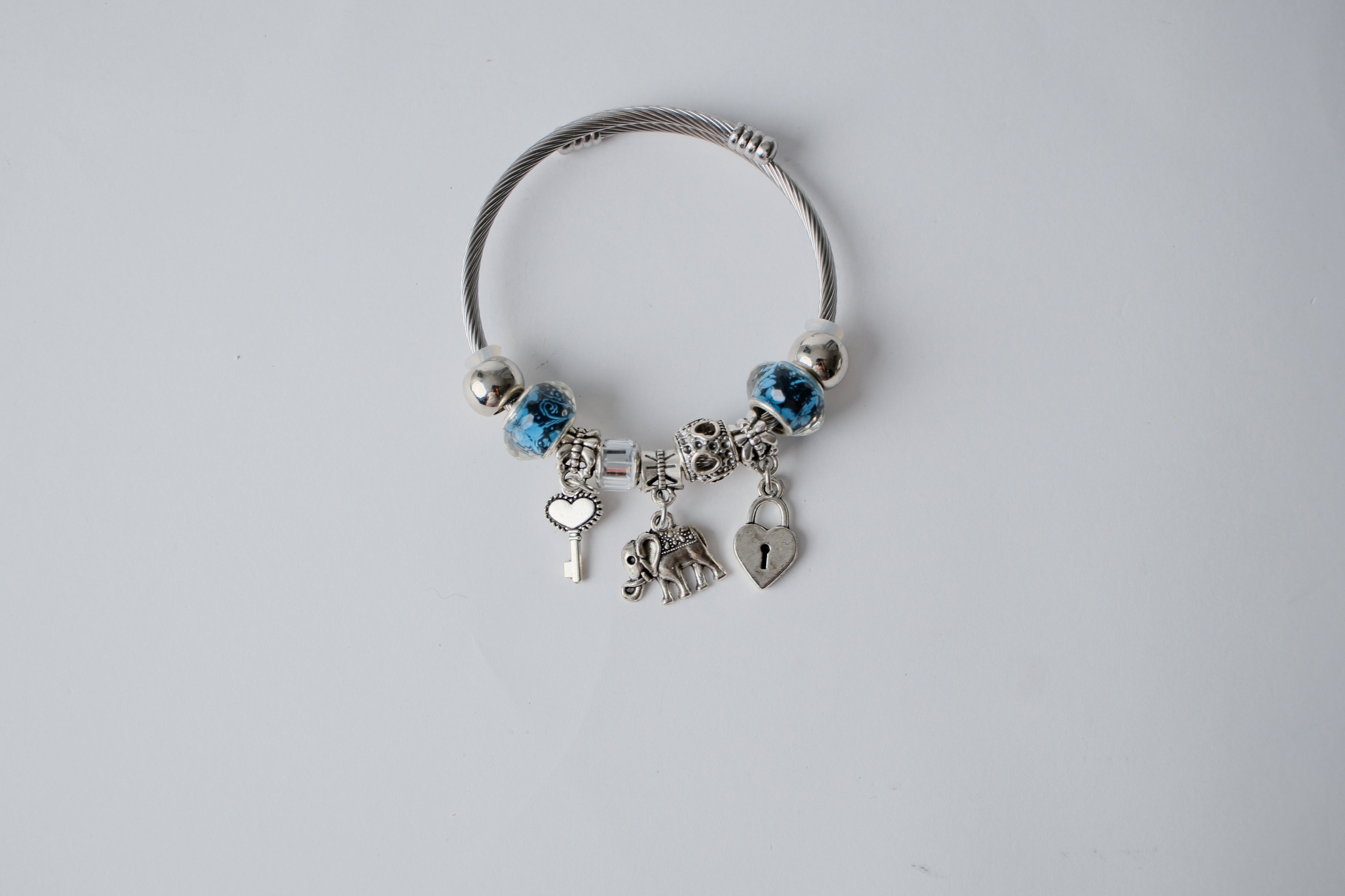 Pandora charm bracelet featuring an elephant, heart lock, and key charms