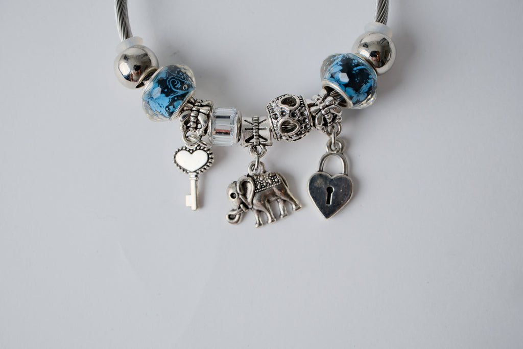 Pandora charm bracelet featuring an elephant, heart lock, and key charms