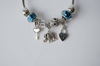 Pandora charm bracelet featuring an elephant, heart lock, and key charms