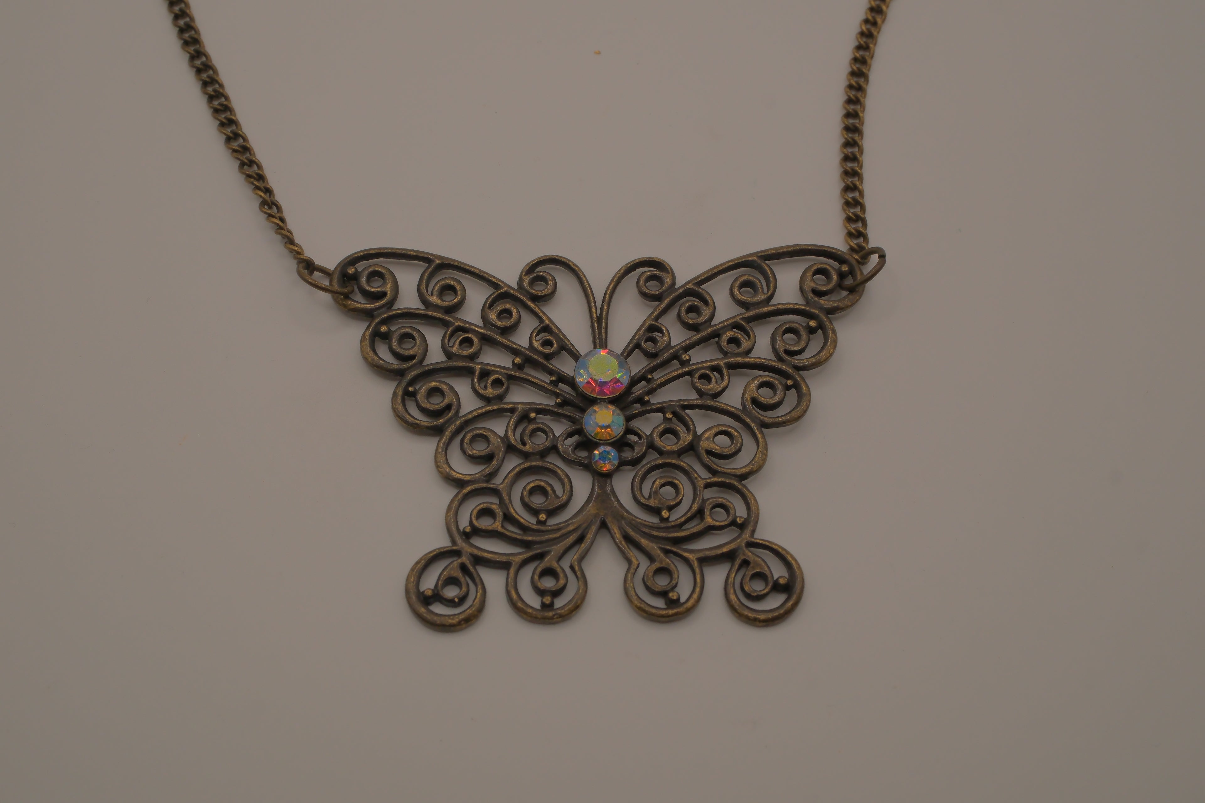 Antique brass-finished filigree butterfly bib necklace