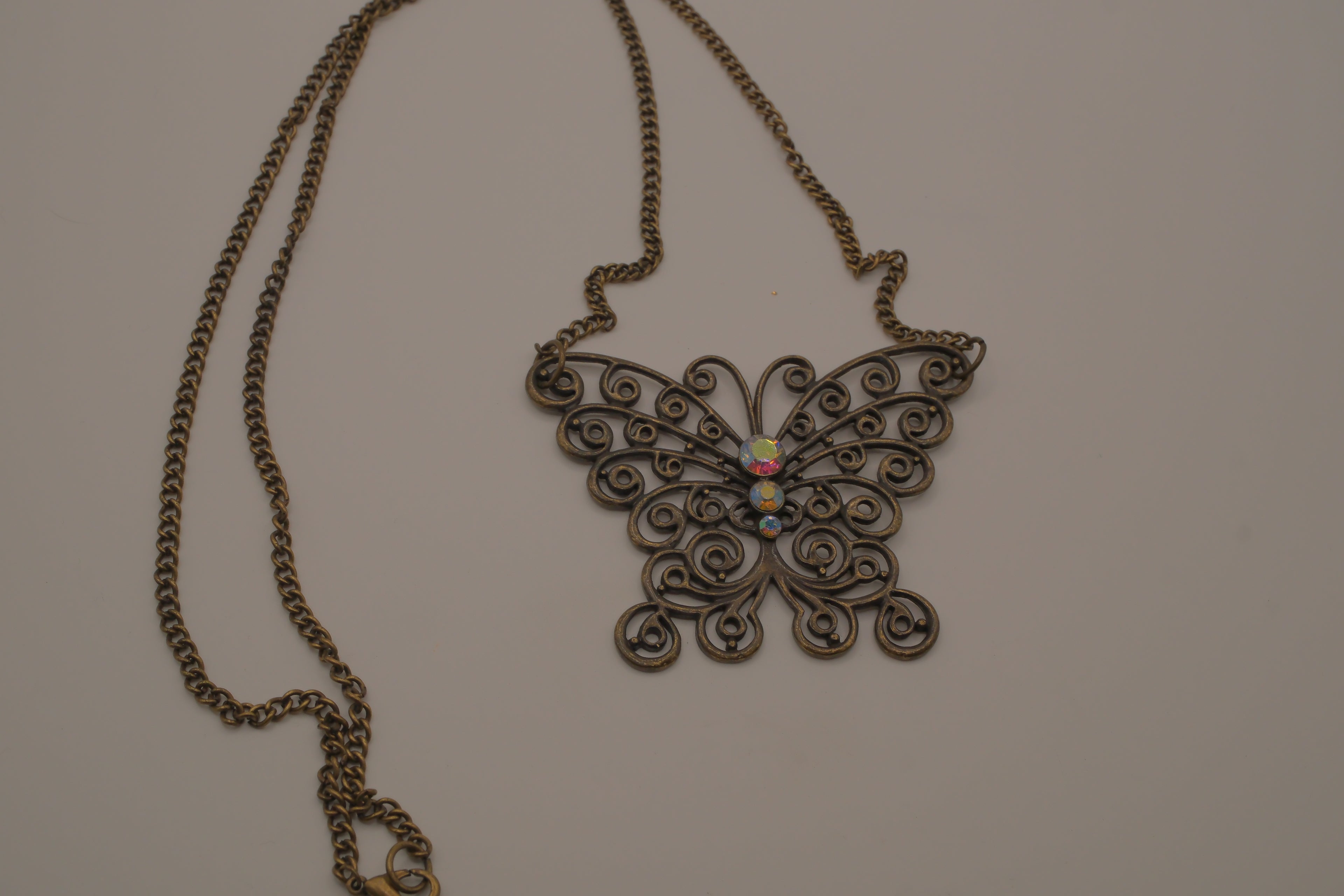 Antique brass-finished filigree butterfly bib necklace