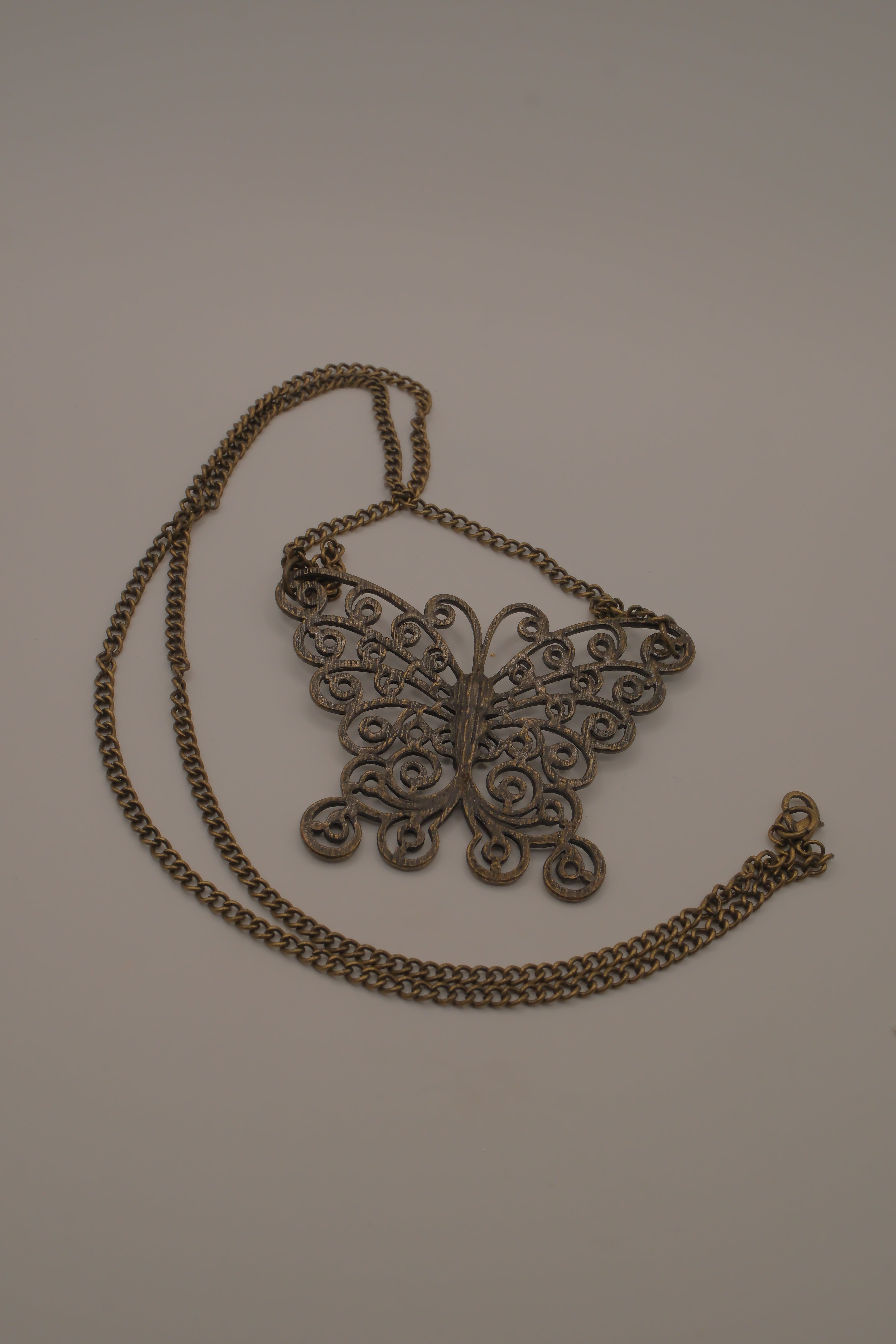 Antique brass-finished filigree butterfly bib necklace