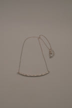 Silver tone curved bar necklace