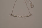 Silver tone curved bar necklace