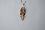Gold Tone Feather Pendant Pave Articulated Necklace