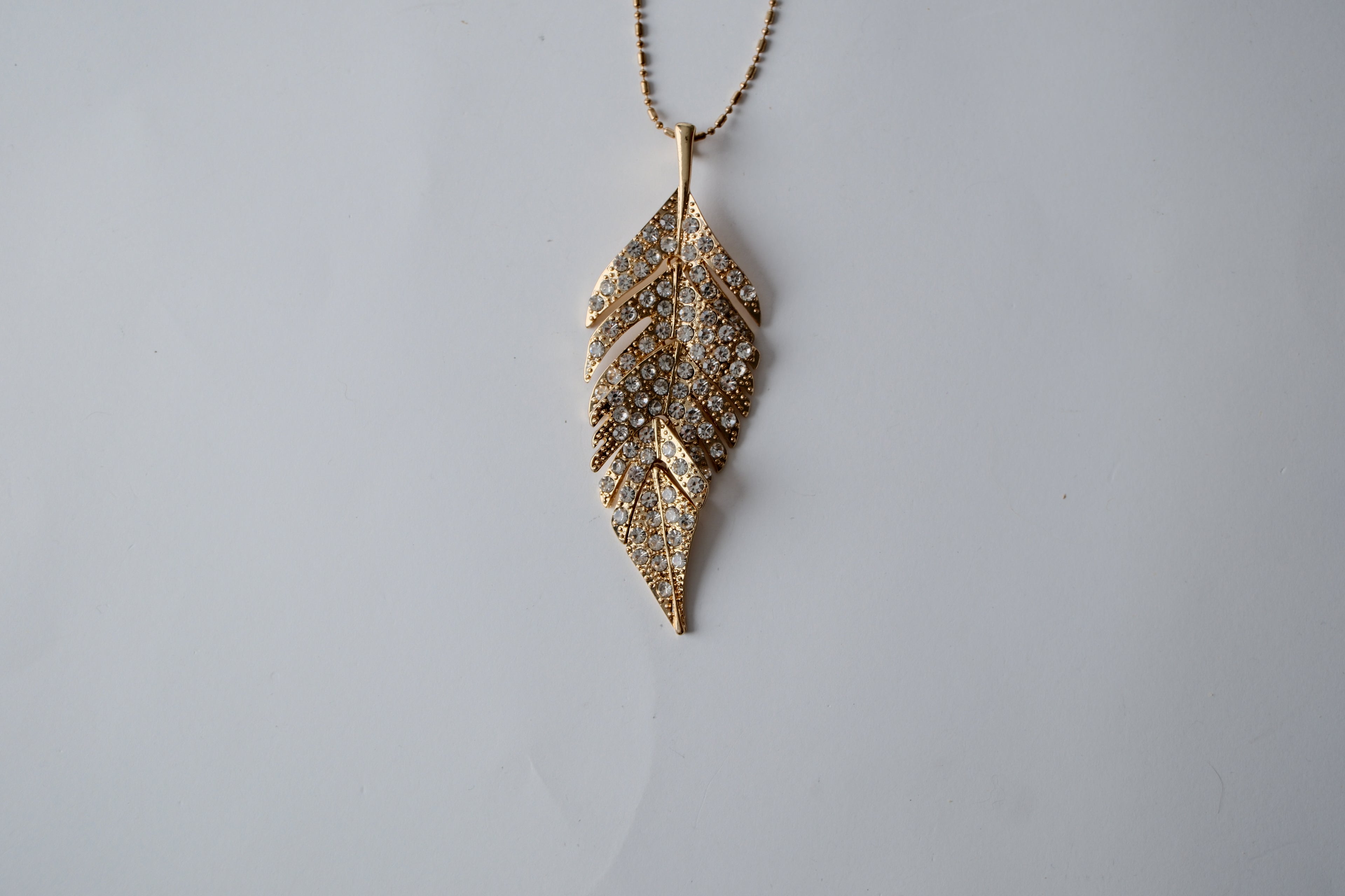 Gold Tone Feather Pendant Pave Articulated Necklace