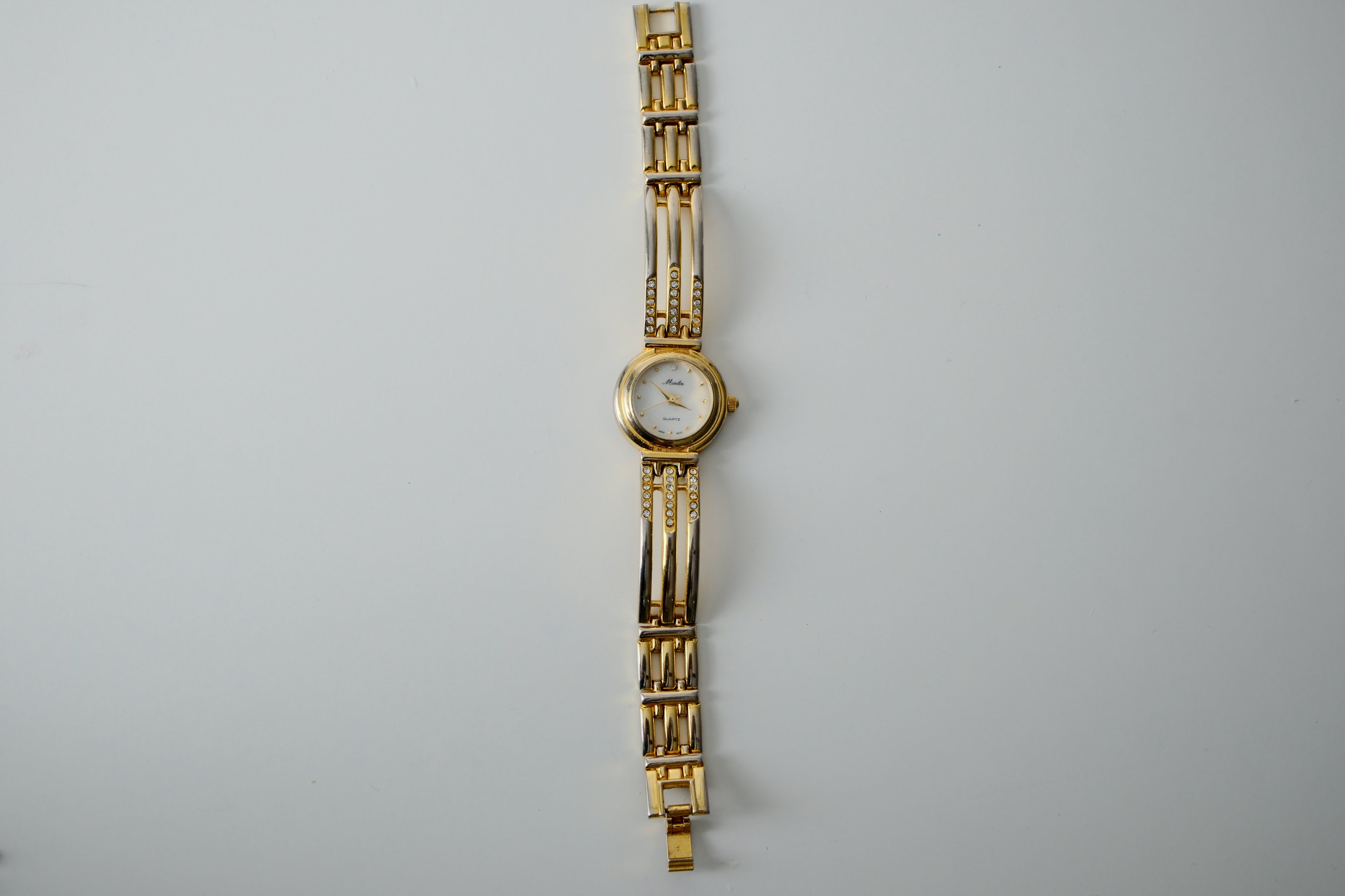 Vintage Minlin Gold Tone link watch with white rhinestones