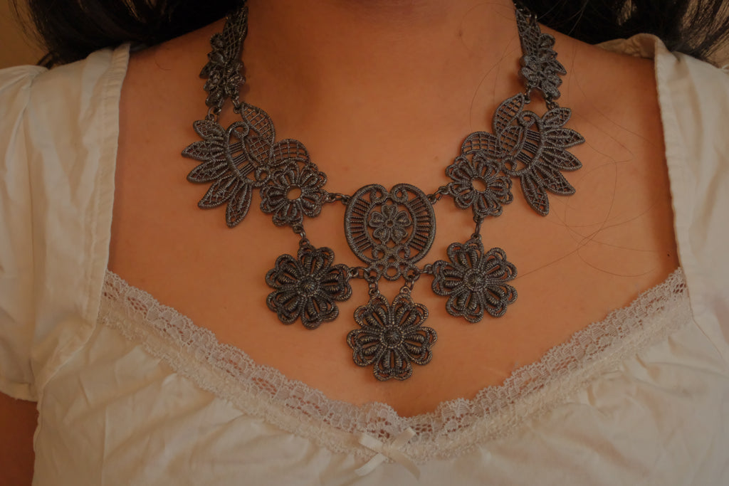 Black filigree bib statement necklace
