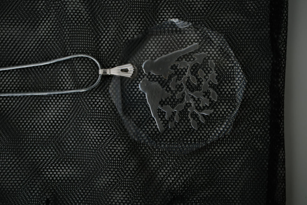 Sterling silver chain with an etched design of 2 birds