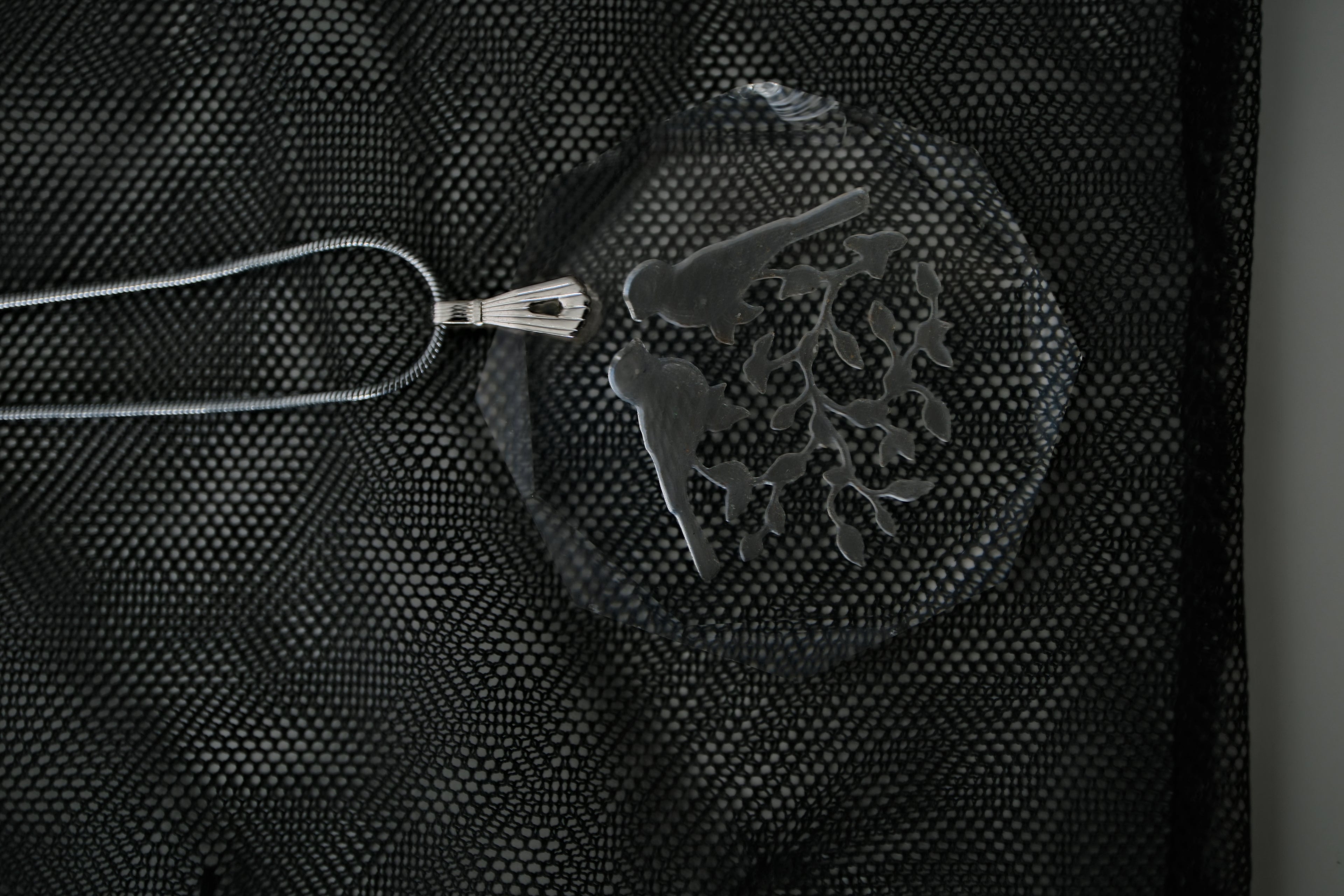 Sterling silver chain with an etched design of 2 birds