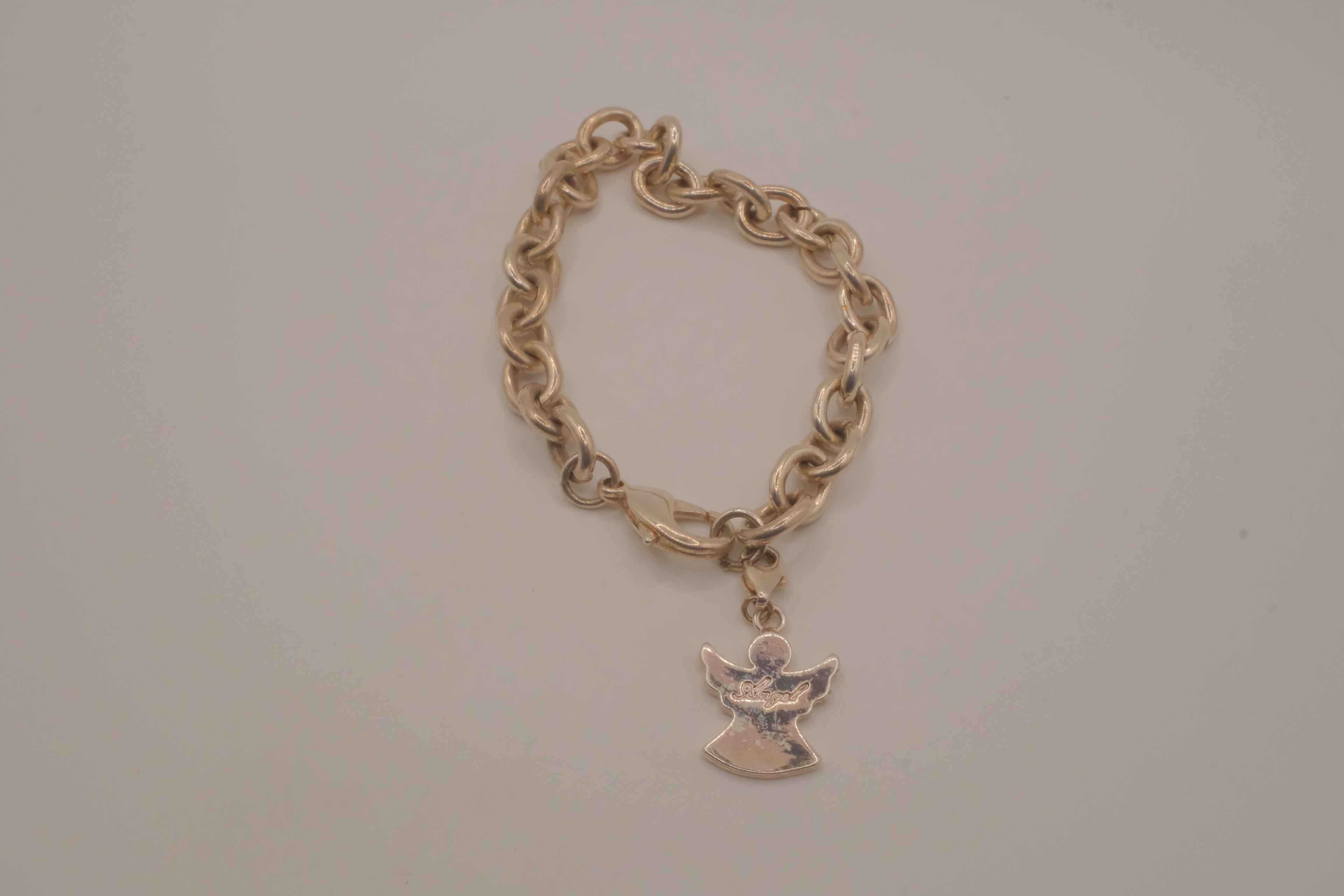 Sterling silver charm bracelet with an angel pendant