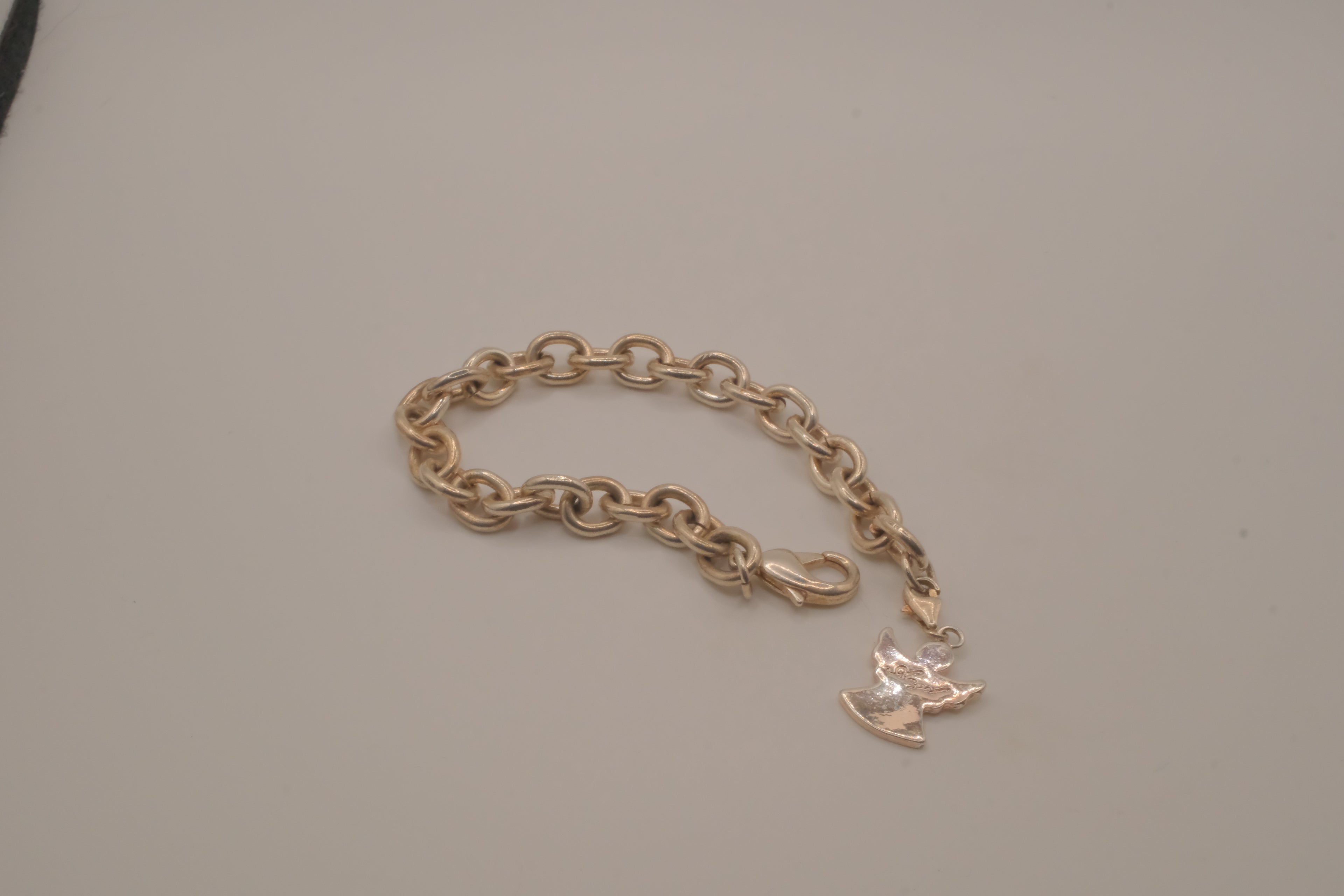 Sterling silver charm bracelet with an angel pendant
