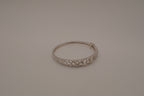 Sterling silver interlocking heart pattern hinged bangle bracelet