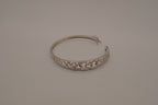 Sterling silver interlocking heart pattern hinged bangle bracelet