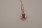 Oval-cut red gemstone halo pendant necklace