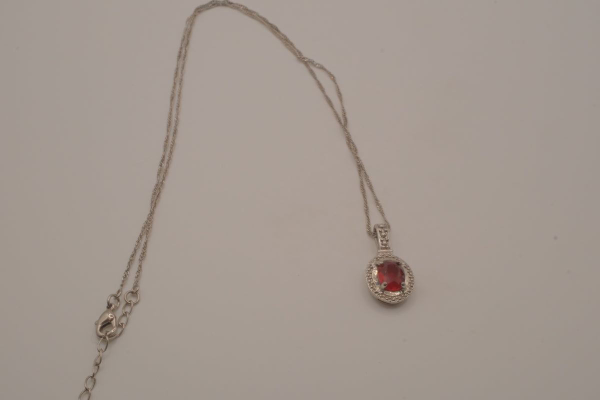 Oval-cut red gemstone halo pendant necklace