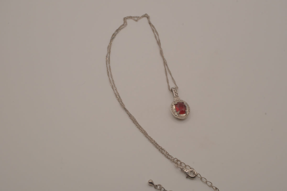 Oval-cut red gemstone halo pendant necklace