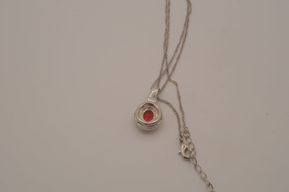 Oval-cut red gemstone halo pendant necklace