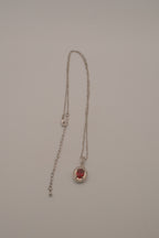 Oval-cut red gemstone halo pendant necklace