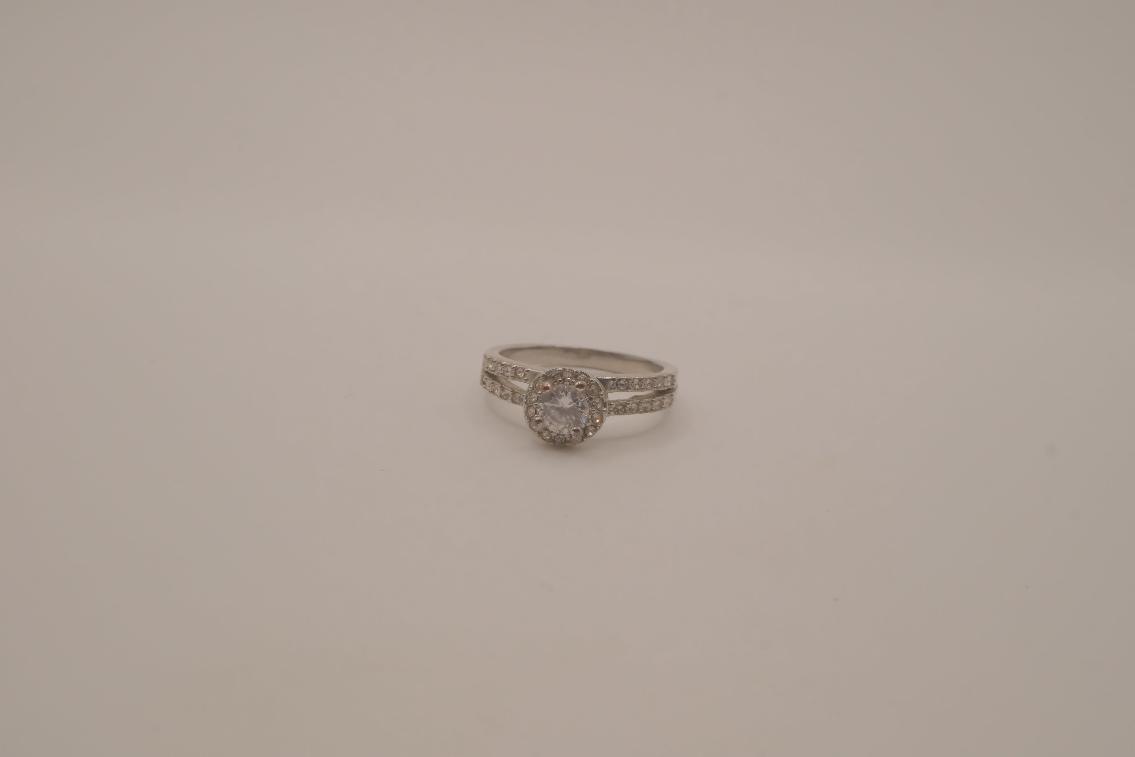Silver tone halo ring with split-shank band