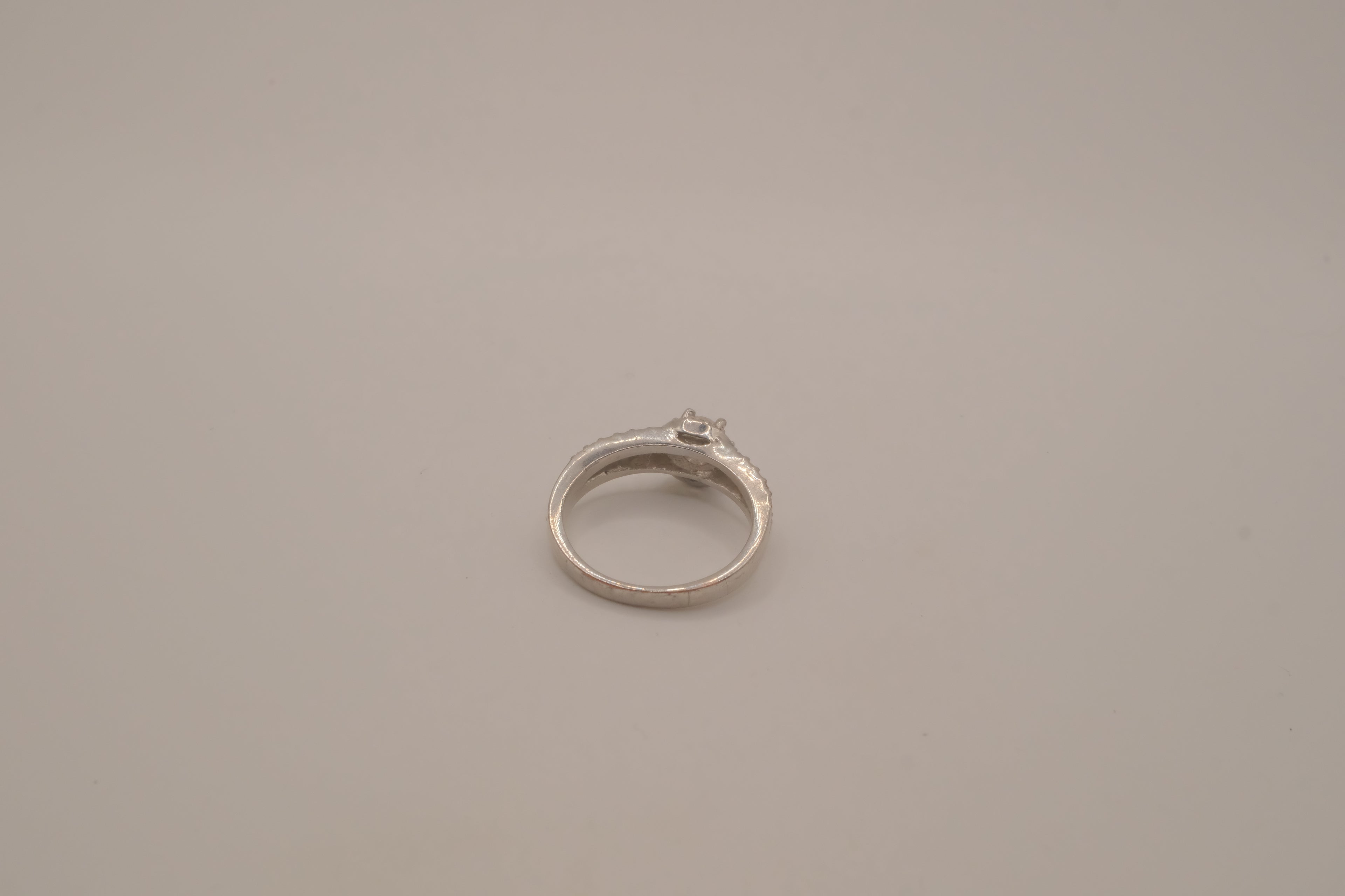 Silver tone halo ring with split-shank band