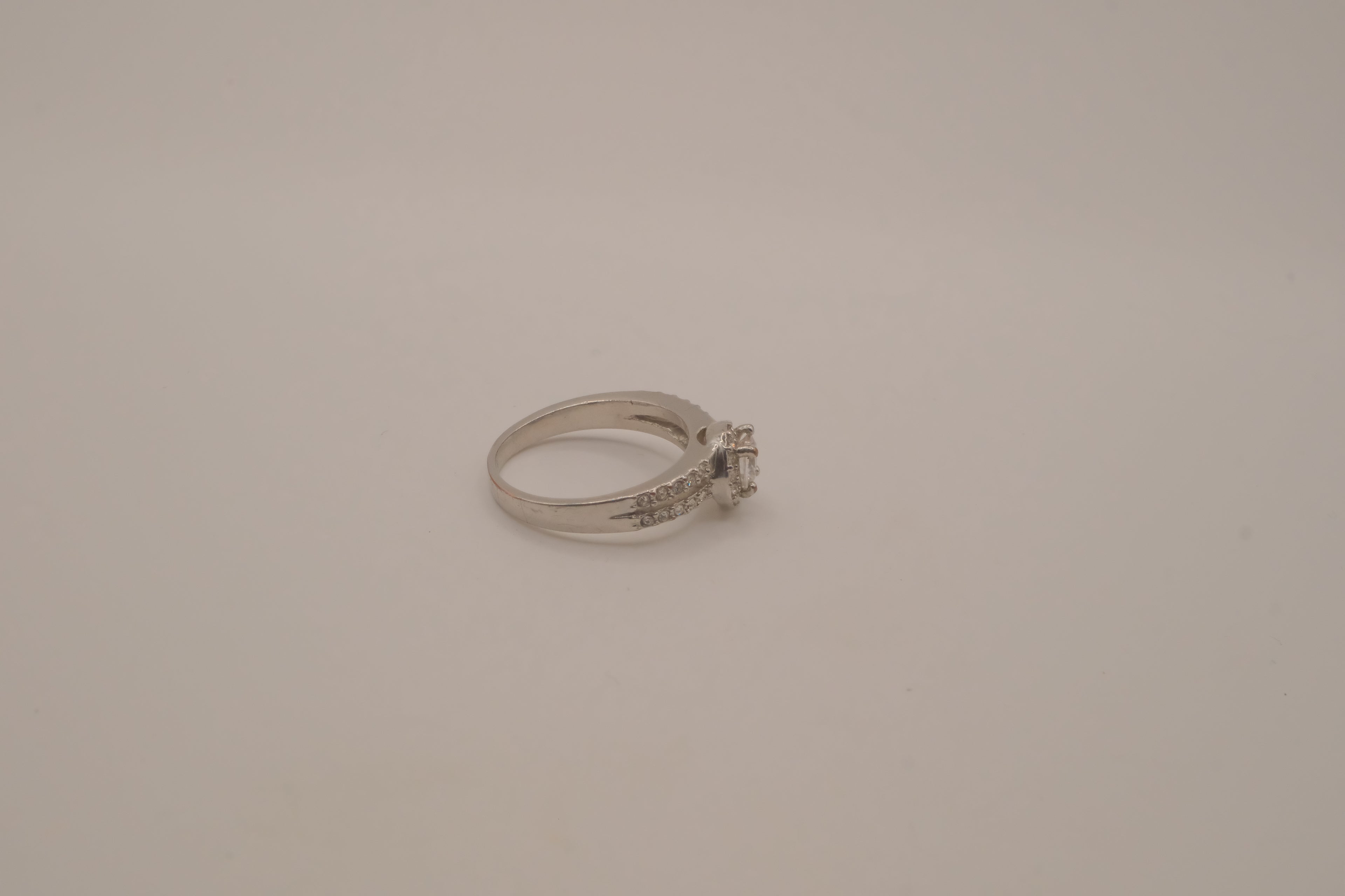 Silver tone halo ring with split-shank band