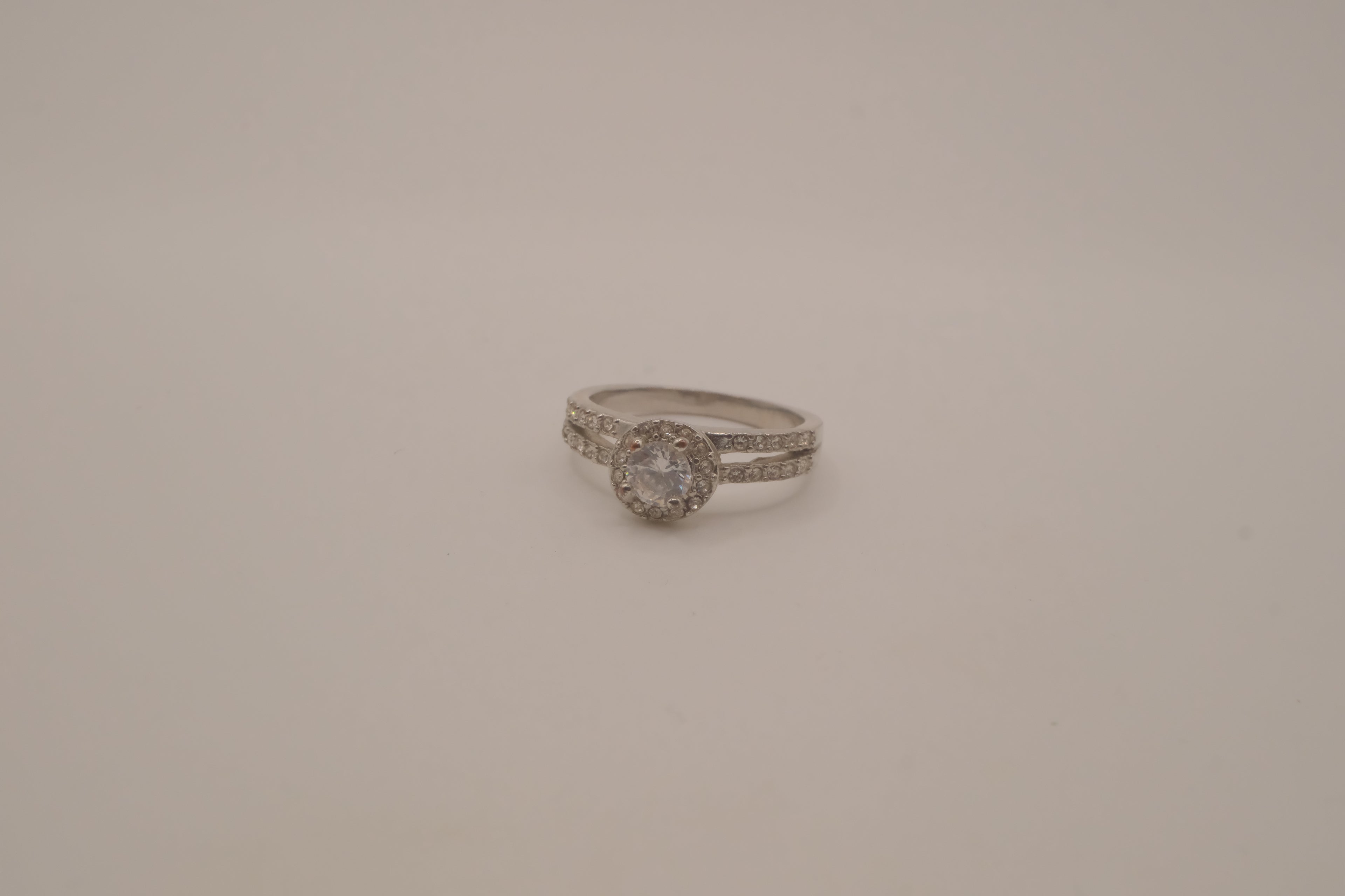 Silver tone halo ring with split-shank band