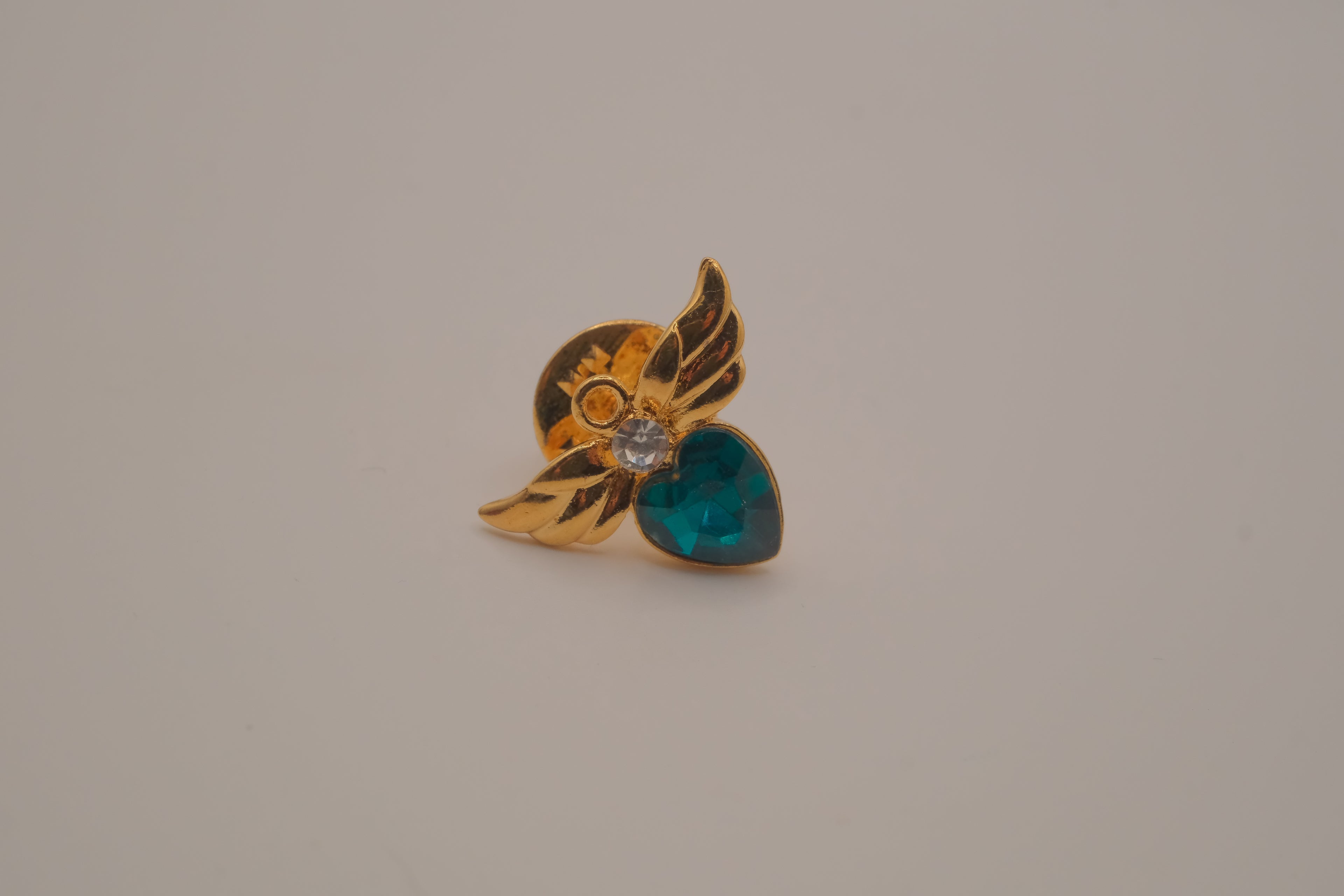 Vintage Avon gold-tone angel May birthstone lapel/bag  pin