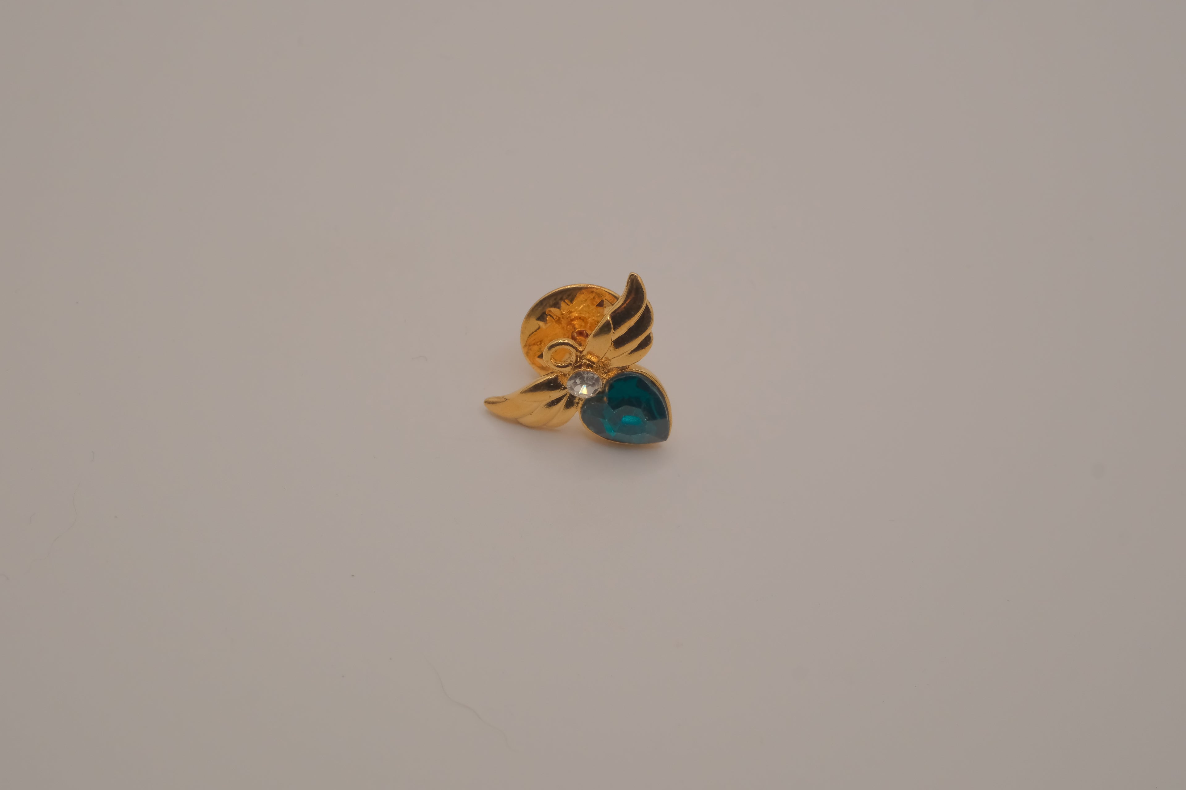Vintage Avon gold-tone angel May birthstone lapel/bag  pin