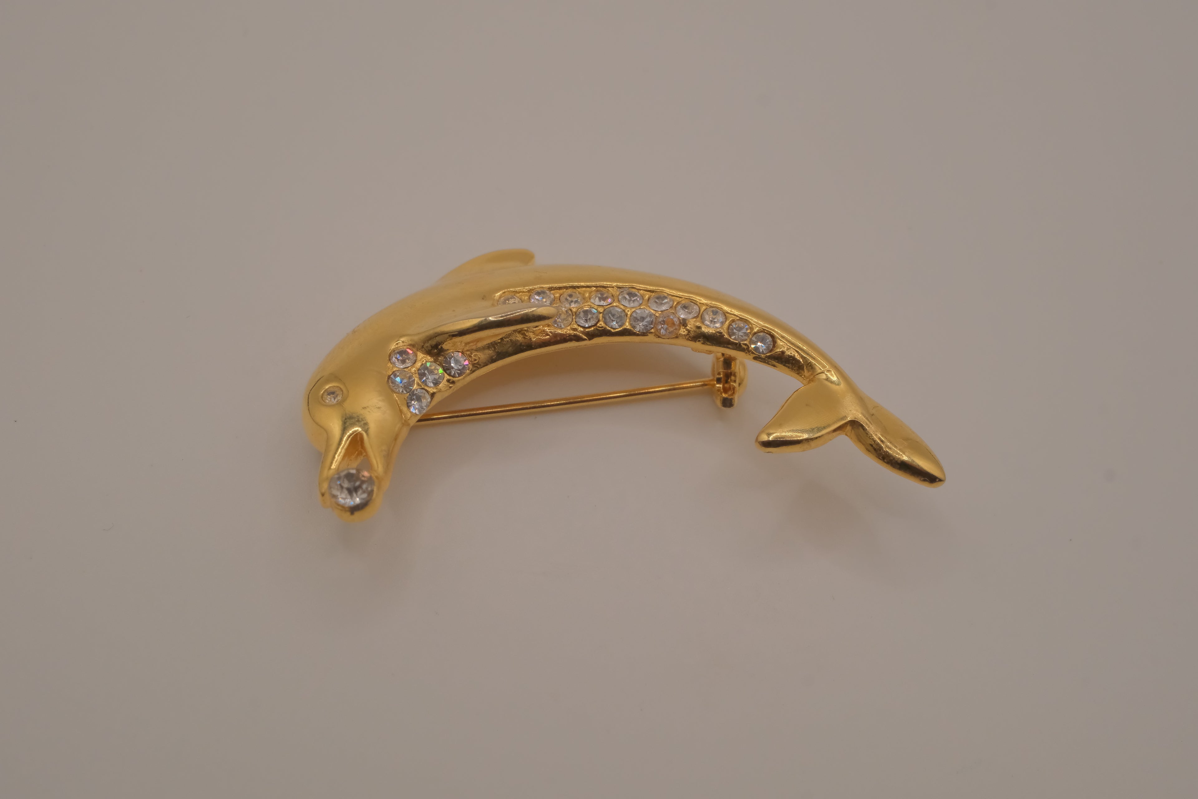 Vintage gold-tone leaping dolphin brooch pin