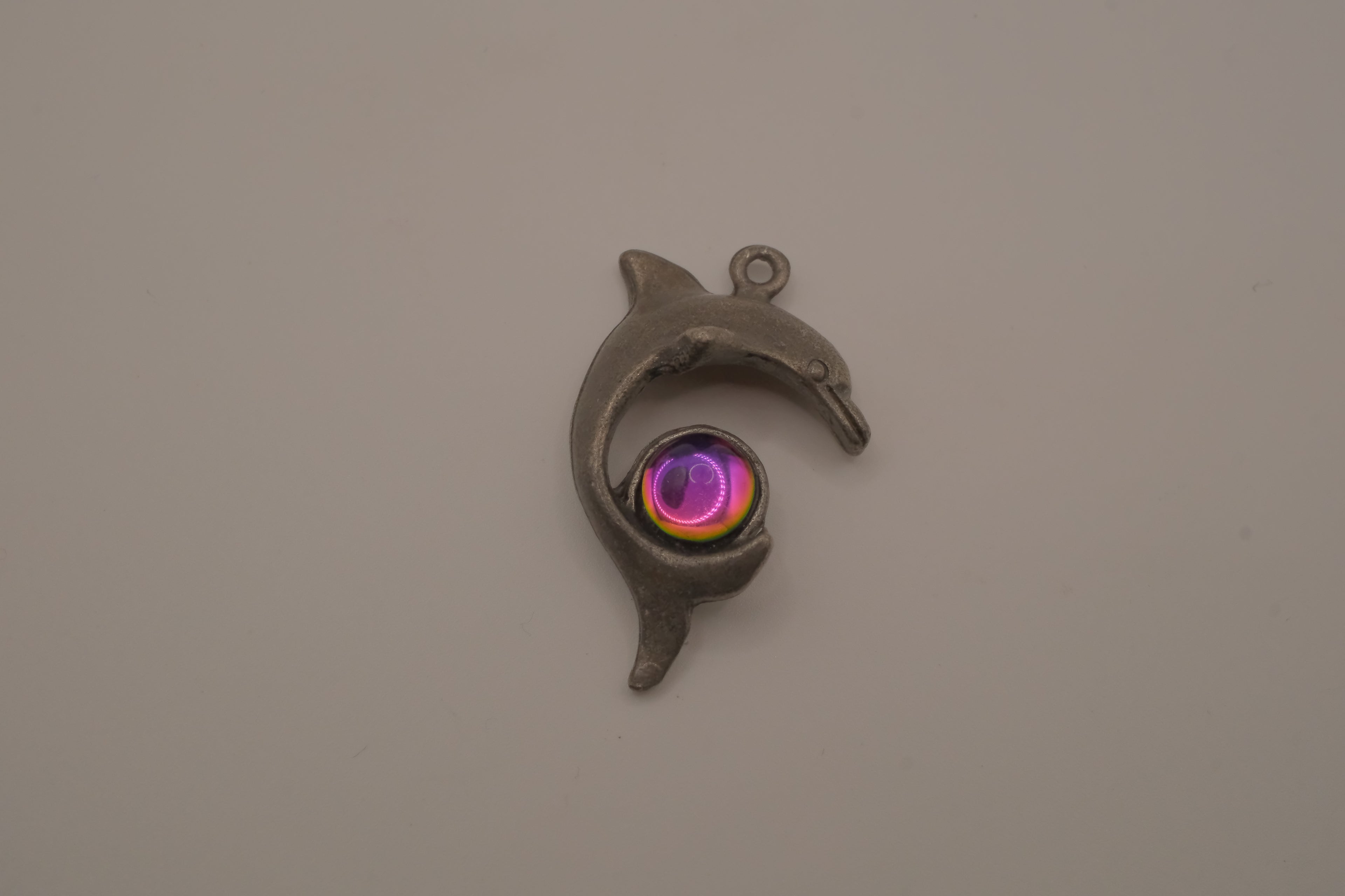 Vintage pewter dolphin pendant with an iridescent glass orb