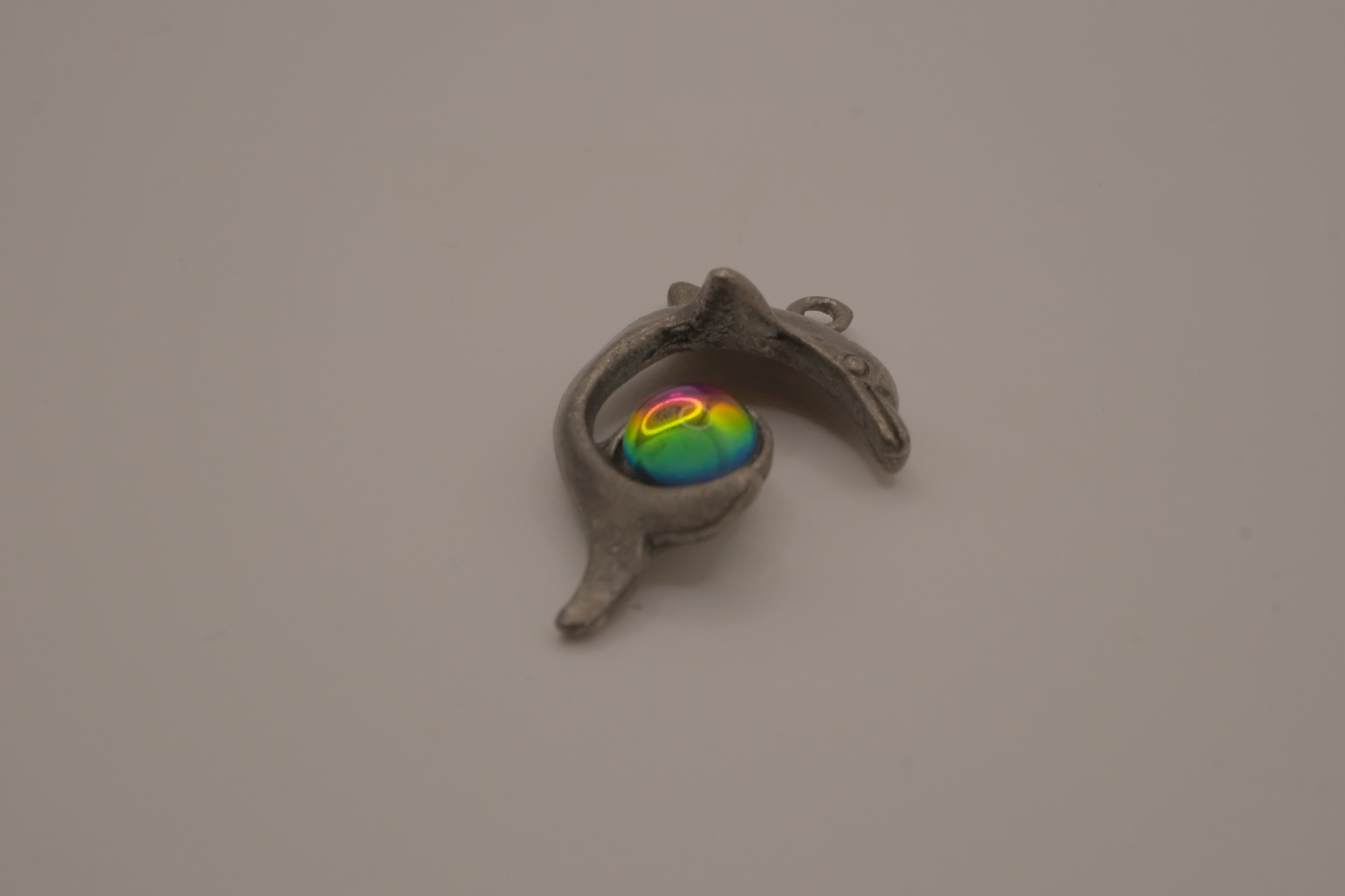 Vintage pewter dolphin pendant with an iridescent glass orb
