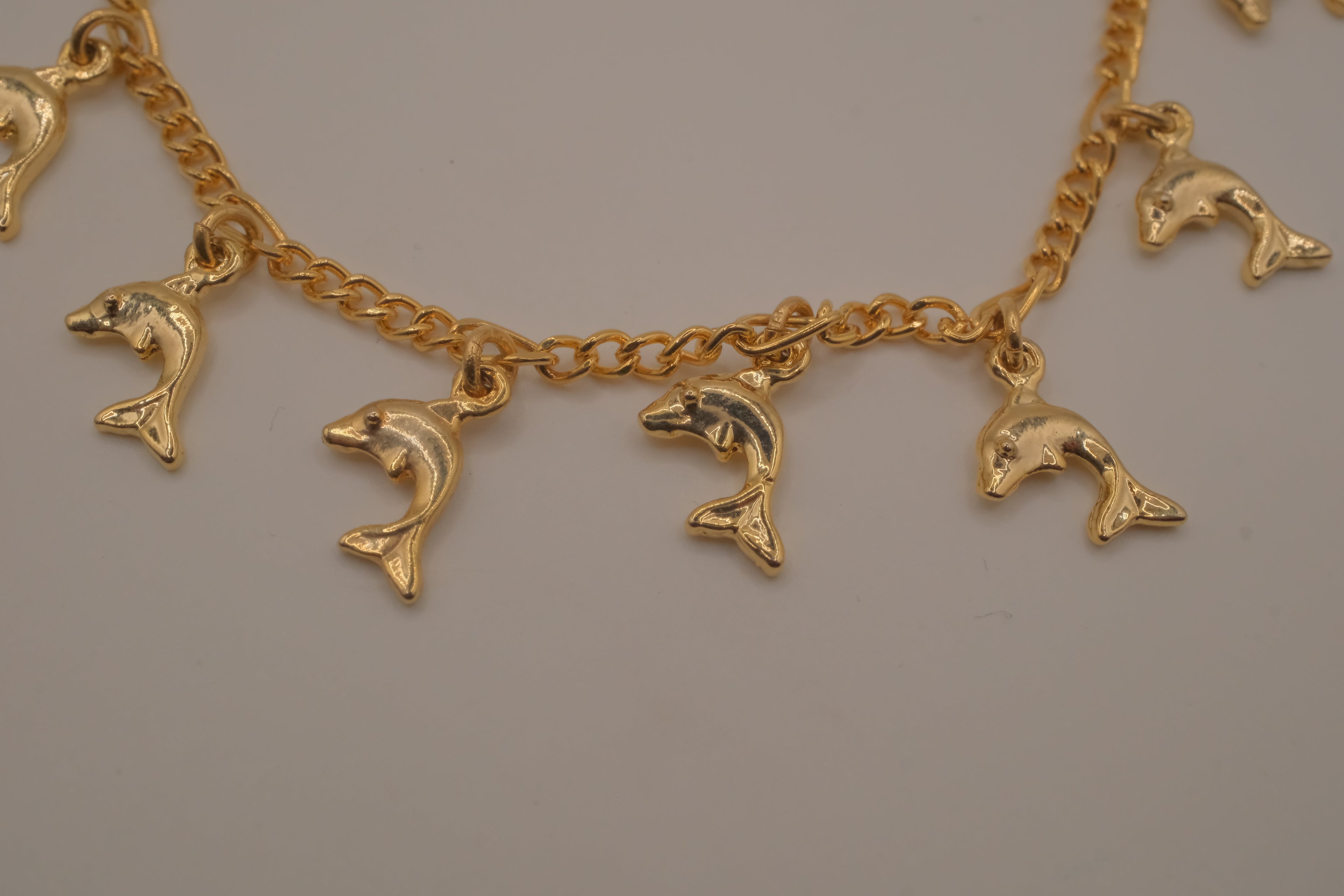 Gold tone Dolphin charm bracelet