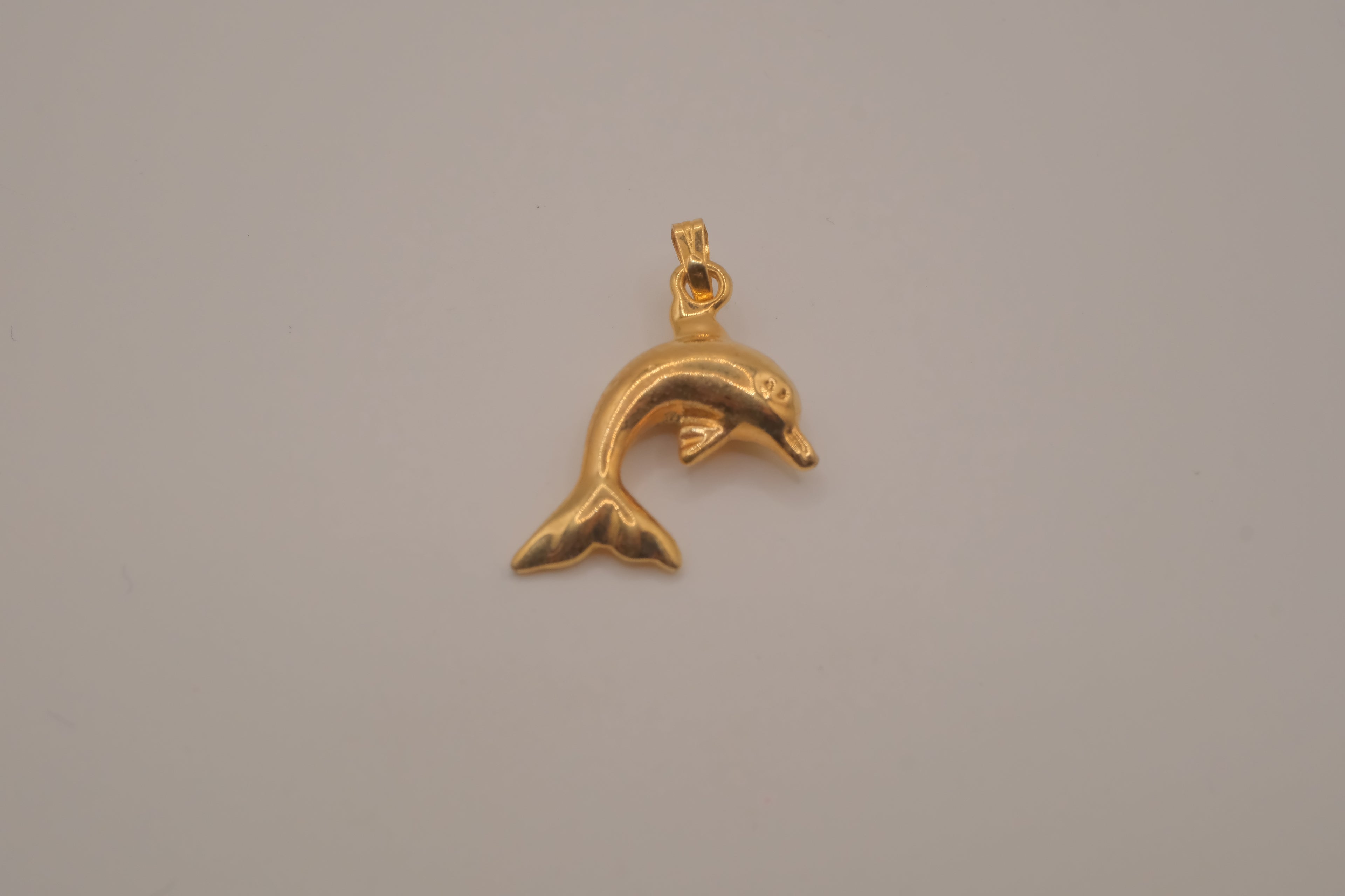Classic gold toned dolphin pendant