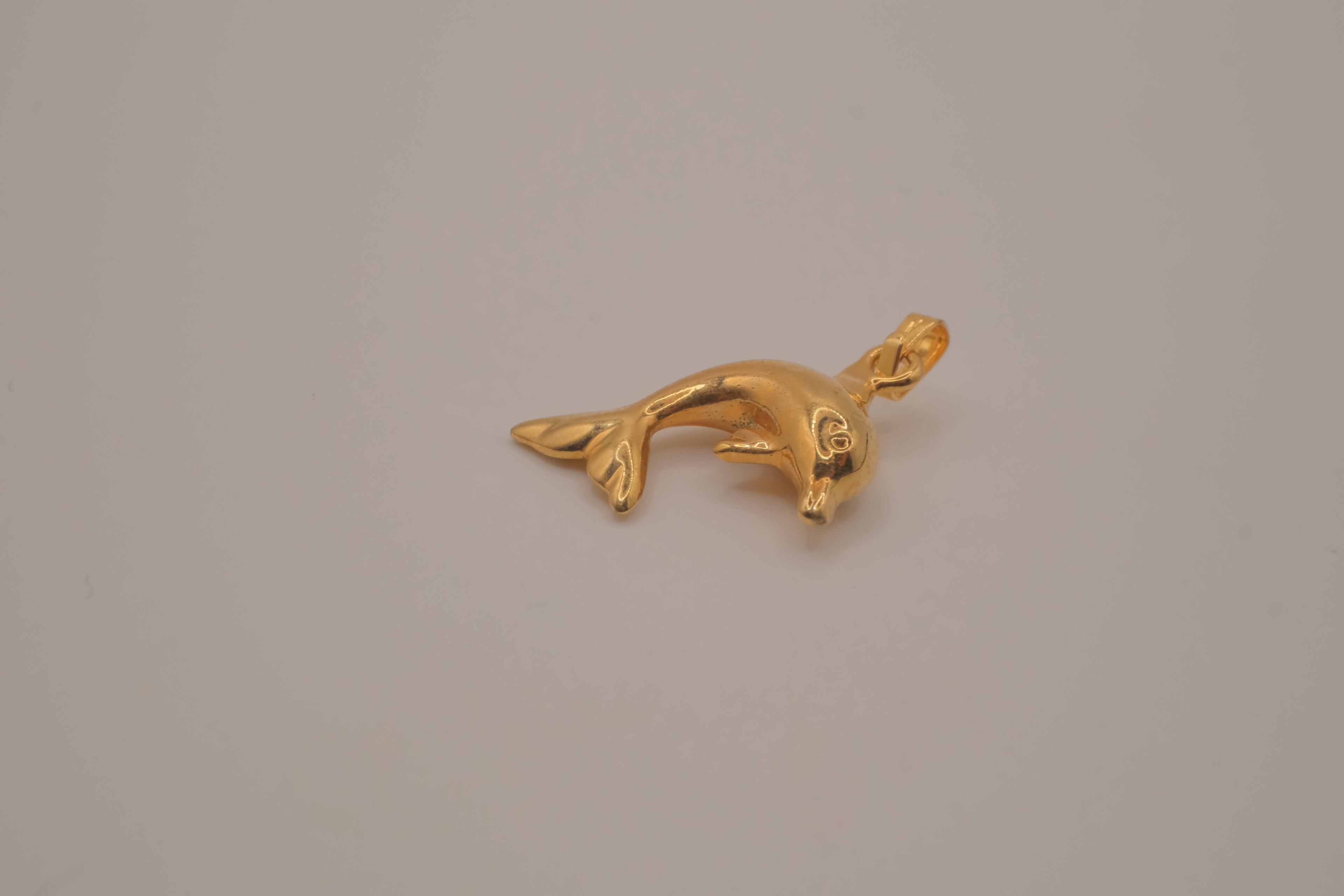 Classic gold toned dolphin pendant