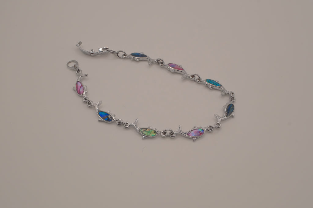 Silver-tone dolphin link bracelet featuring colorful abalone shell inlays