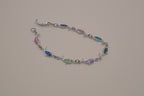 Silver-tone dolphin link bracelet featuring colorful abalone shell inlays