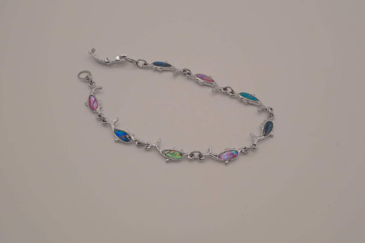 Silver-tone dolphin link bracelet featuring colorful abalone shell inlays