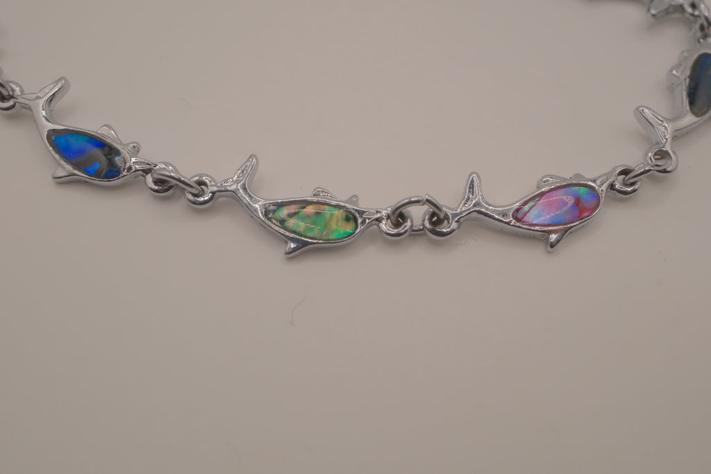 Silver-tone dolphin link bracelet featuring colorful abalone shell inlays