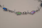 Silver-tone dolphin link bracelet featuring colorful abalone shell inlays