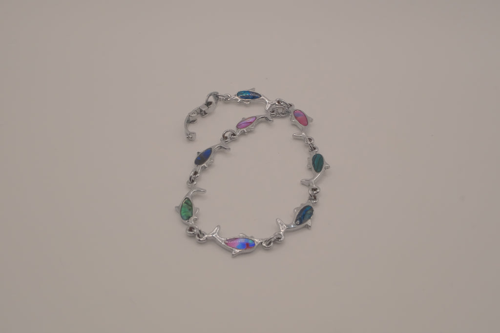 Silver-tone dolphin link bracelet featuring colorful abalone shell inlays