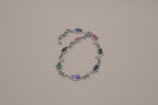 Silver-tone dolphin link bracelet featuring colorful abalone shell inlays