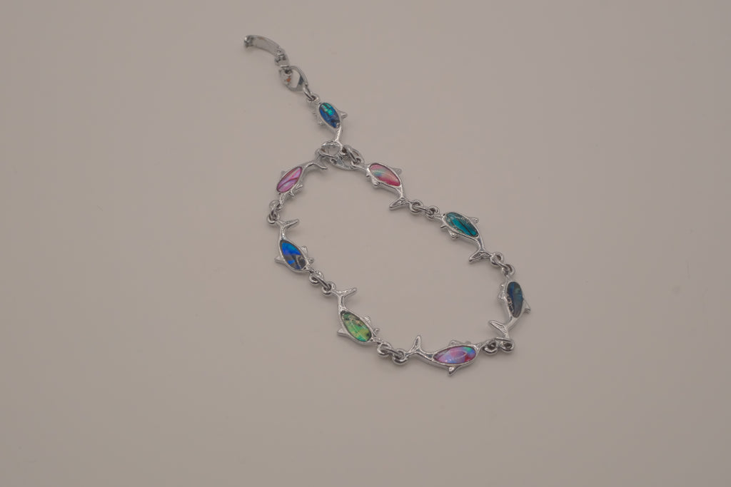Silver-tone dolphin link bracelet featuring colorful abalone shell inlays