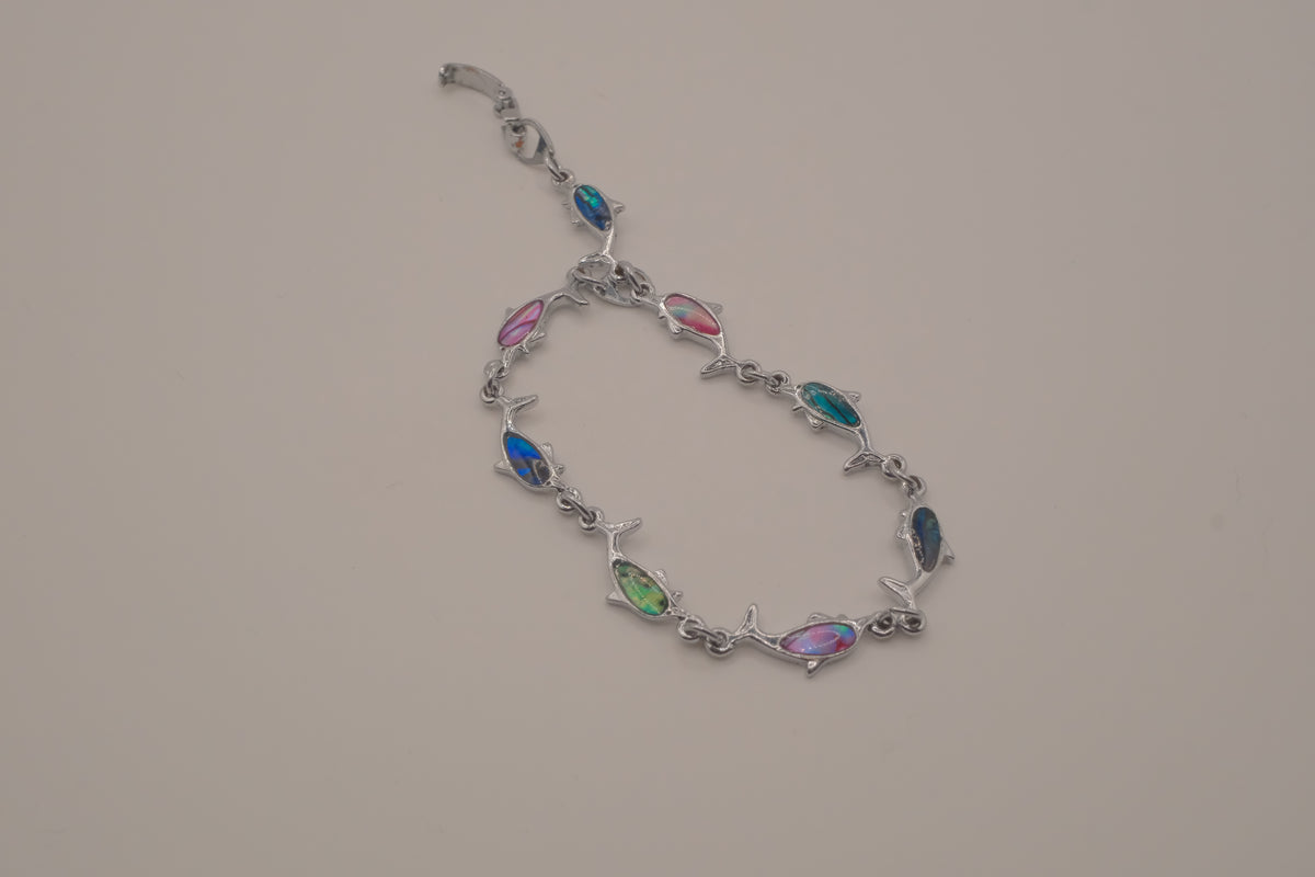 Silver-tone dolphin link bracelet featuring colorful abalone shell inlays
