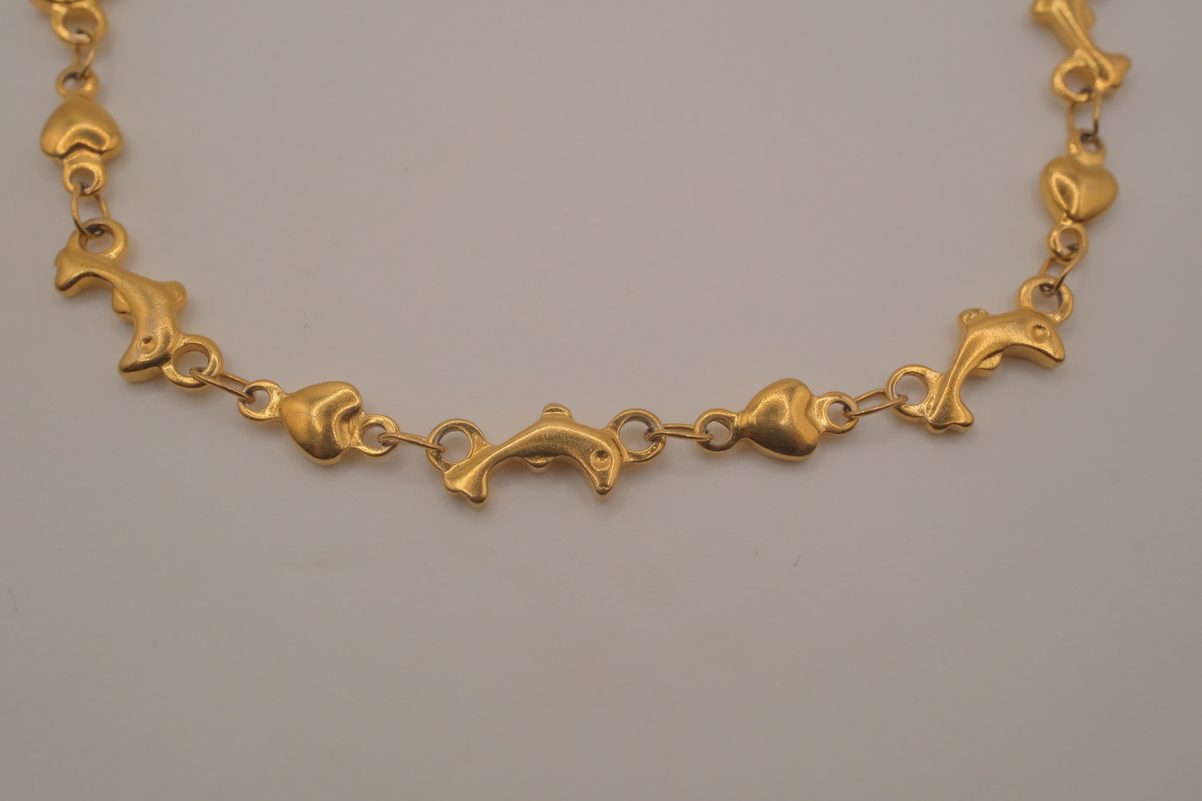 Gold tone Dolphin &amp; Hearts link bracelet