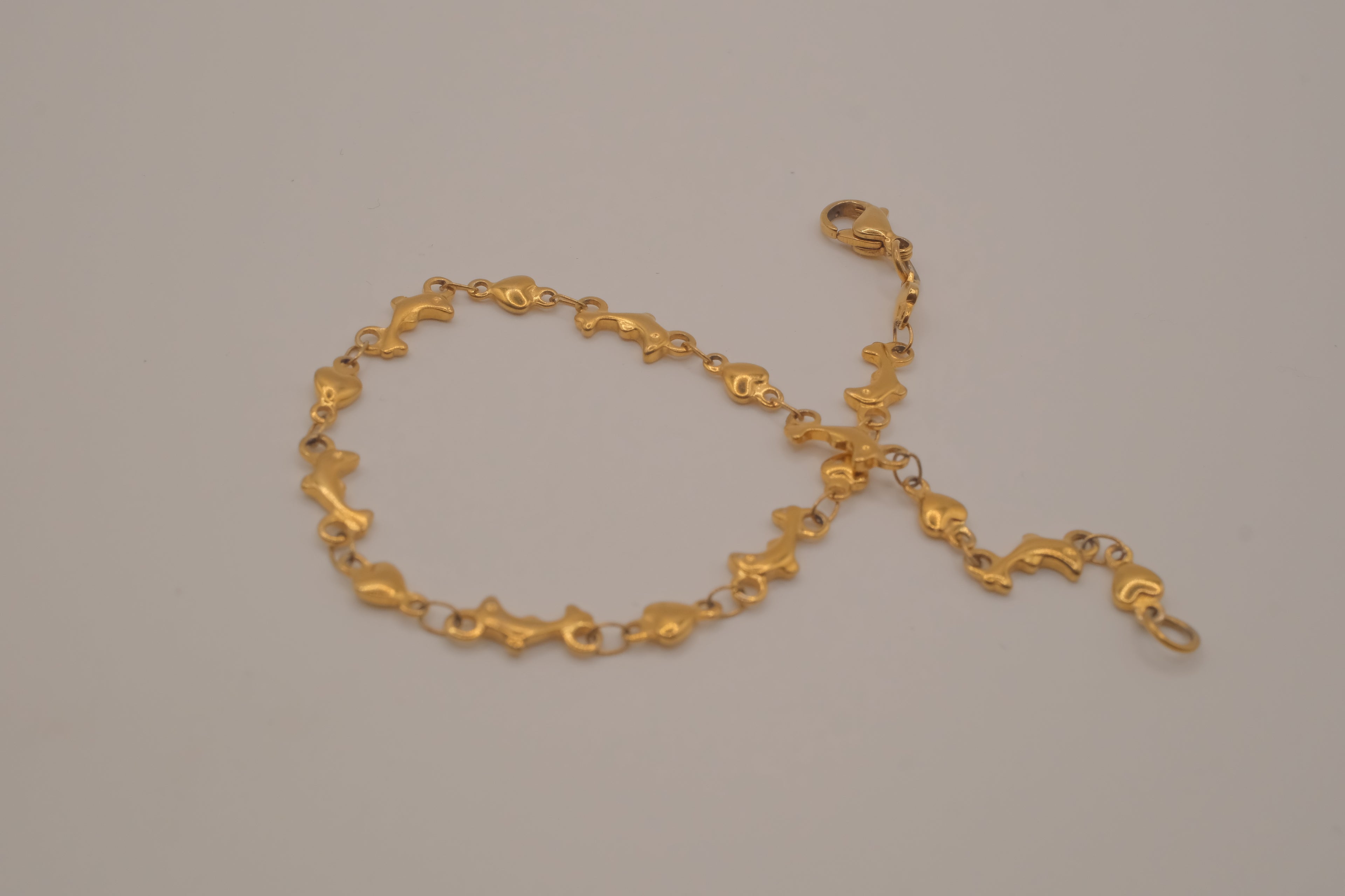 Gold tone Dolphin &amp; Hearts link bracelet