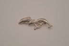 Vintage silver tone three-dolphin brooch